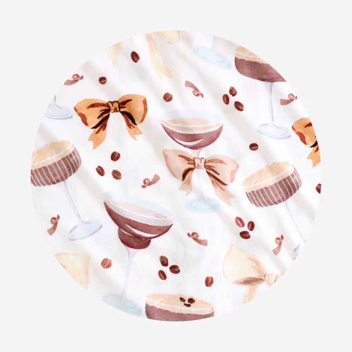 Circle swatch with espresso martini, cupcake, and bow pattern on a white background