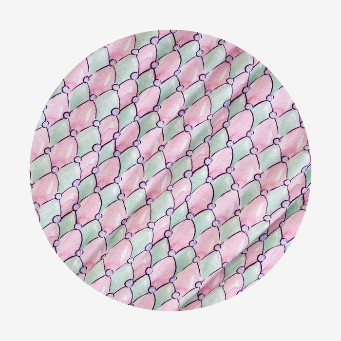 Round pink and green patterned diamonds on a white background