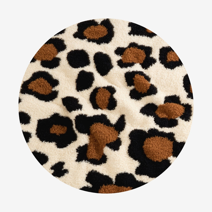 Round rug with leopard print pattern on a white background