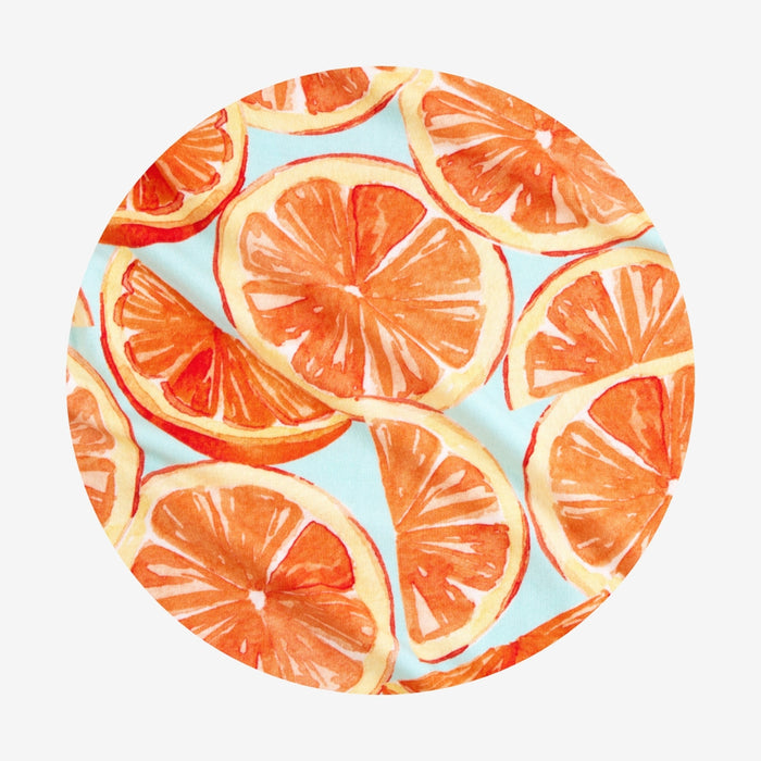 circle fabric swatch of orange slices on a light blue background