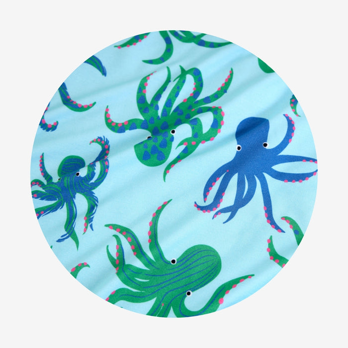 Round pattern swatch with blue and green octopus pattern on a light blue background