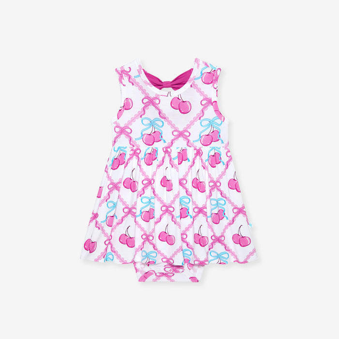 Baby romper with cherry and bow pattern on a white background