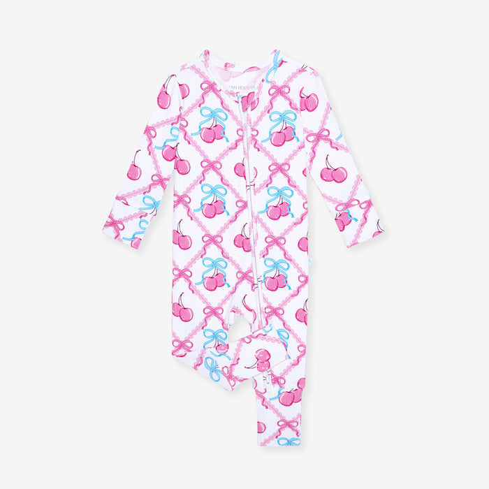 Children's one piece with pink and blue bow pattern on a white background