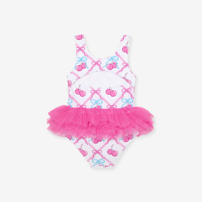 Children's swimsuit with pink tutu and bow pattern on a white background