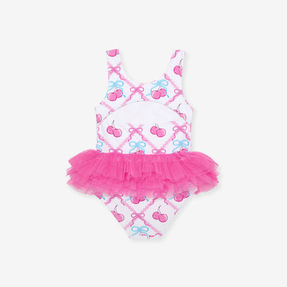 Children's swimsuit with pink tutu and bow pattern on a white background