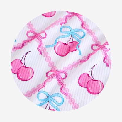 Round fabric with pink cherries and blue bows on a white background