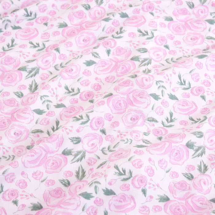 Pattern of pink roses with green leaves on a white background