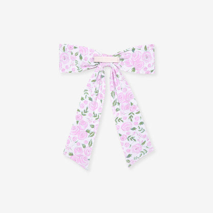 back detail of rose printed hair bow on a white background