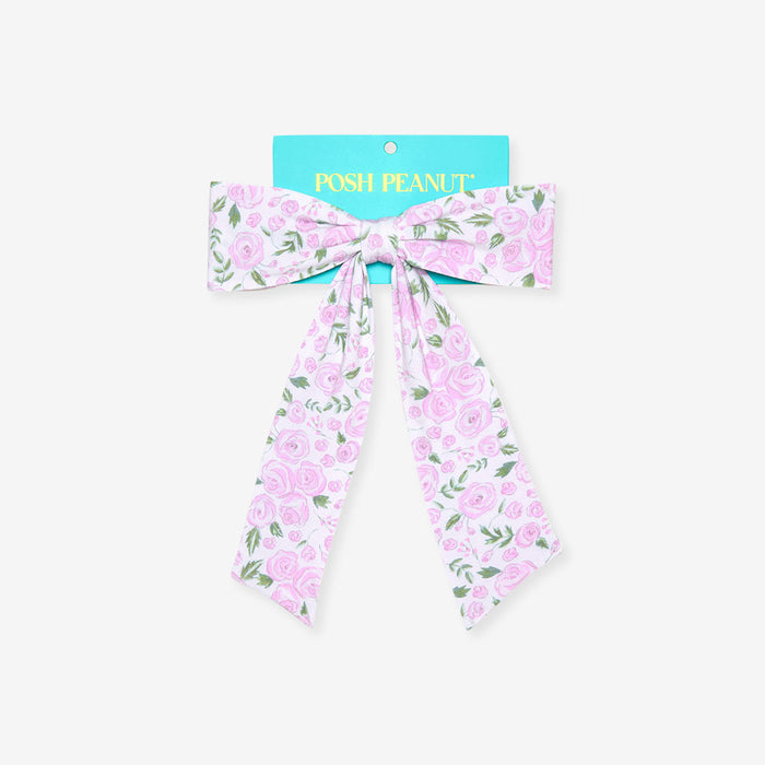 Rose printed bow with teal brand packaging on a white background