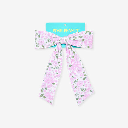 Rose printed bow with teal brand packaging on a white background
