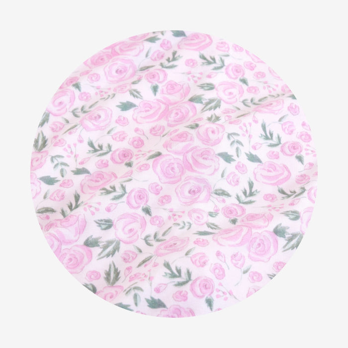 Round pink floral patterned product on a white background
