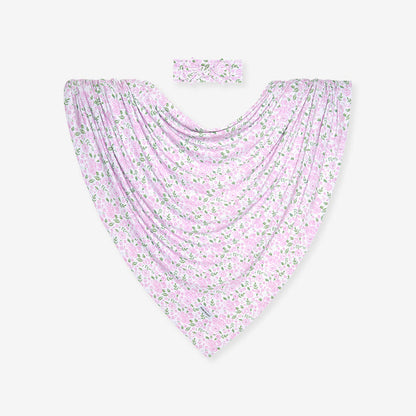 Baby swaddle and headband set with pink floral pattern on a white background