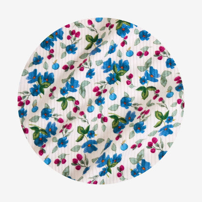 Floral-patterned fabric with blue, pink, and green flowers on a white background