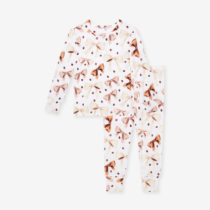 White and brown pajama set with brown bow and coffee beans pattern on a white background