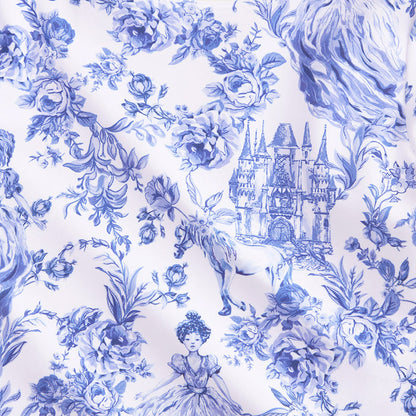 closeup showing blue and white whimsy print with castles, horses, flowers and woman in dress