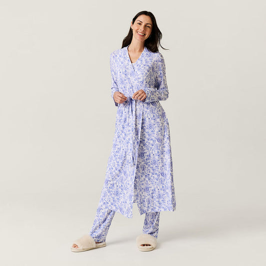 Woman wearing a blue floral robe on a light gray background