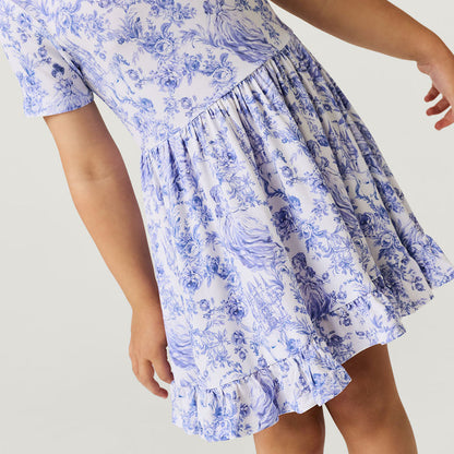 Close-up of blue and white floral dress on a plain background