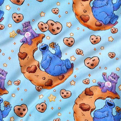 Pattern of blue characters and cookies on a blue background