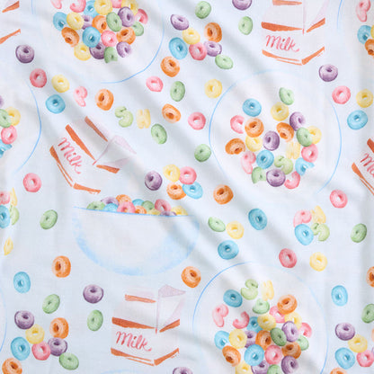 Fabric with colorful cereal loops and milk carton pattern on a white background