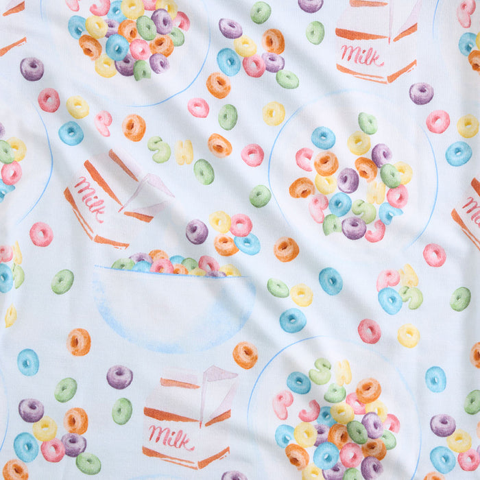 Fabric with colorful cereal loops and milk carton pattern on a white background