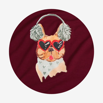 Dog wearing heart-shaped sunglasses and ear muffs on a maroon background