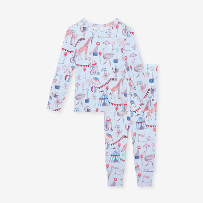 Children's pajama set with circus-themed print on a white background