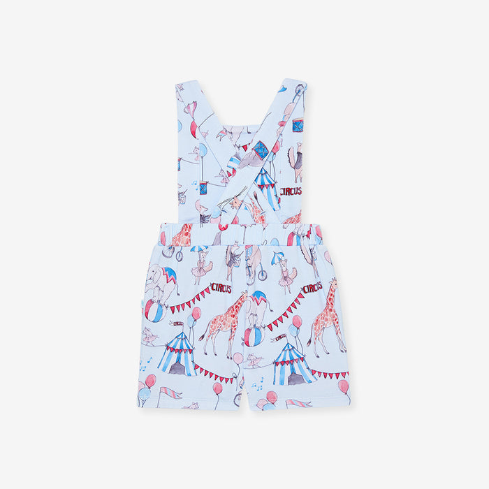back image of children's french terry overall with circus print and criss cross strap detail.