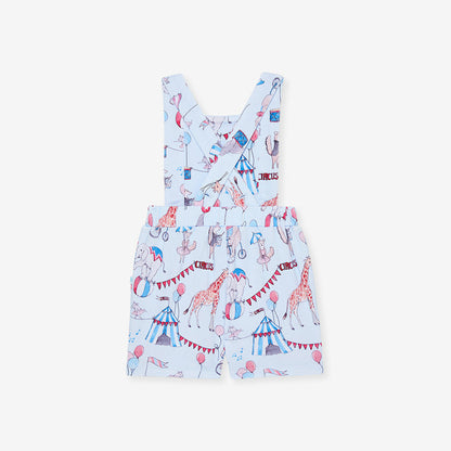 back image of children's french terry overall with circus print and criss cross strap detail.
