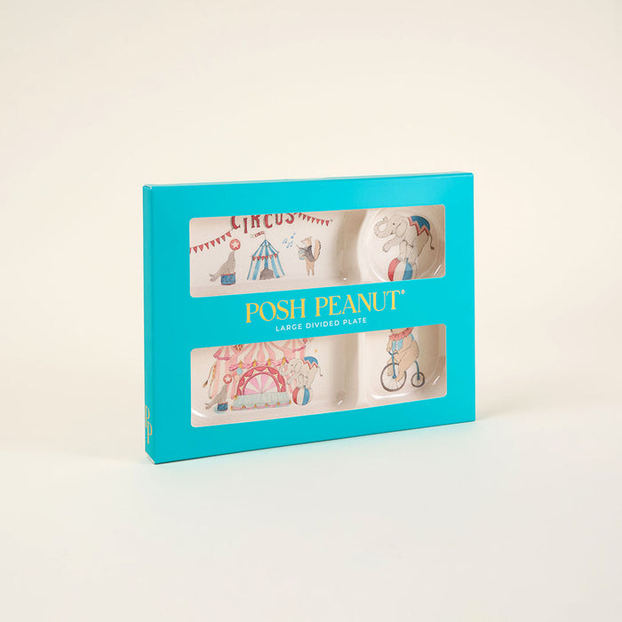 Posh Peanut plate set packaging with circus-themed illustrations on a light beige background
