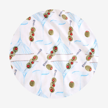 Round fabric swatch with olive and martini pattern on a white background