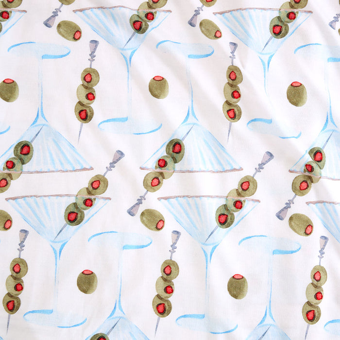 Pattern of martini glasses with olives on a white background