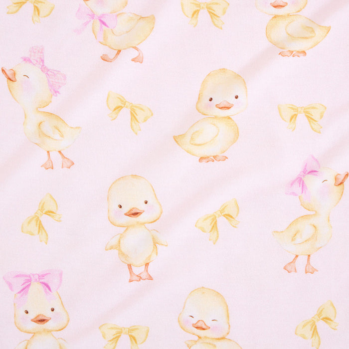 closeup of print with baby chicks and pink and yellow bow ties on a pink background