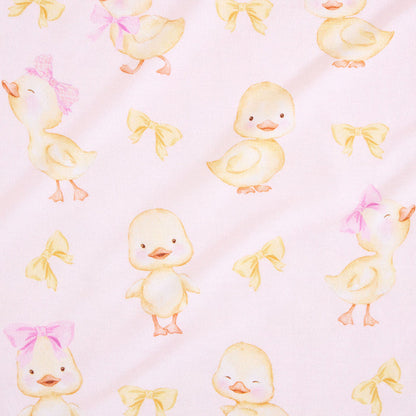 closeup of print with baby chicks and pink and yellow bow ties on a pink background