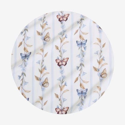 Round fabric swaddle with butterfly and floral pattern on a white background