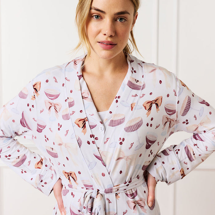 Woman wearing a espresso martini patterned robe with a white background