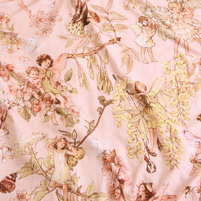 Pattern of fairies and flowers on a light pink background