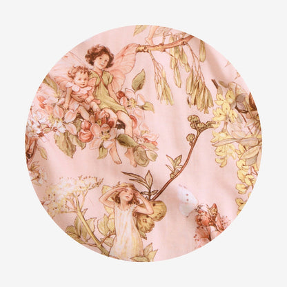Circle swatch of pink fabric with flower fairies.