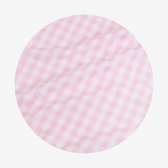 Round pink and white checkered fabric swatch on a light gray background