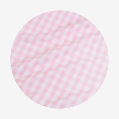 Round pink and white checkered fabric swatch on a light gray background