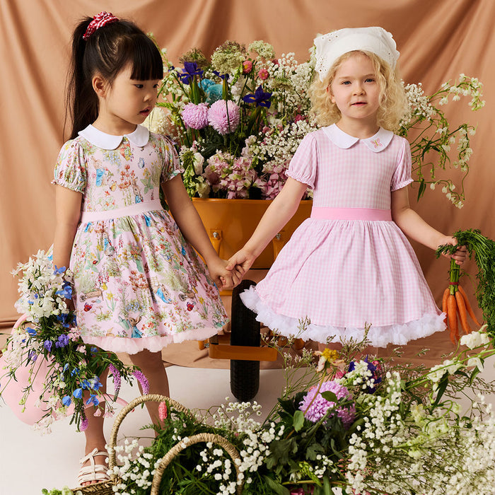 Girls wearing matching bamboo viscose dresses in pink gingham print