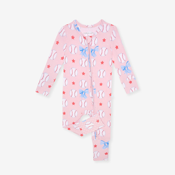 Pink baby one piece with baseball and bow tie pattern on a white background