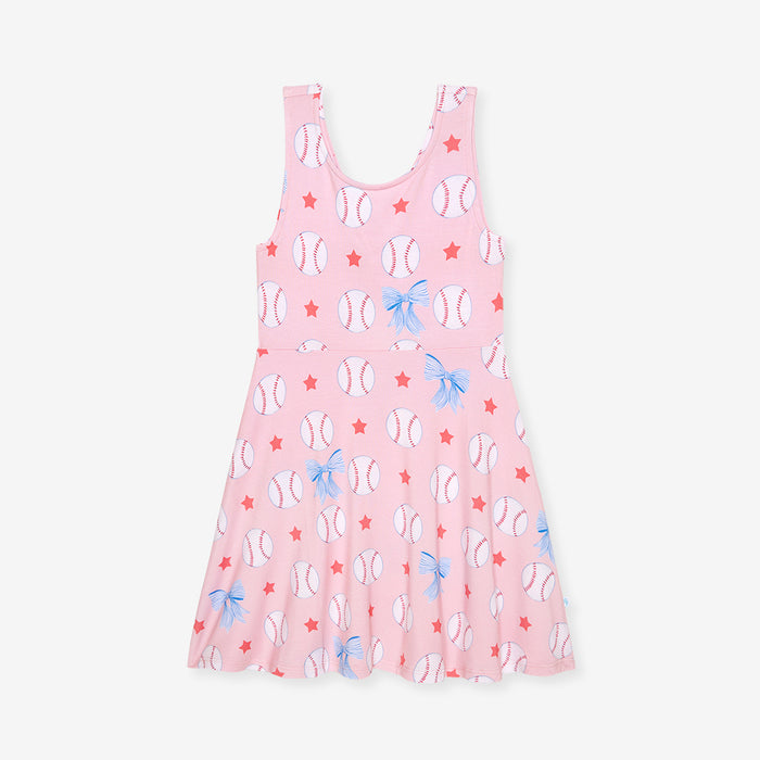 Pink dress with baseball and bow pattern on a white background