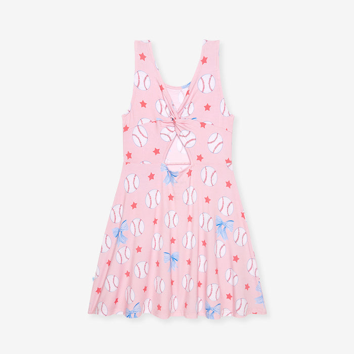 Pink dress with baseball pattern on a white background