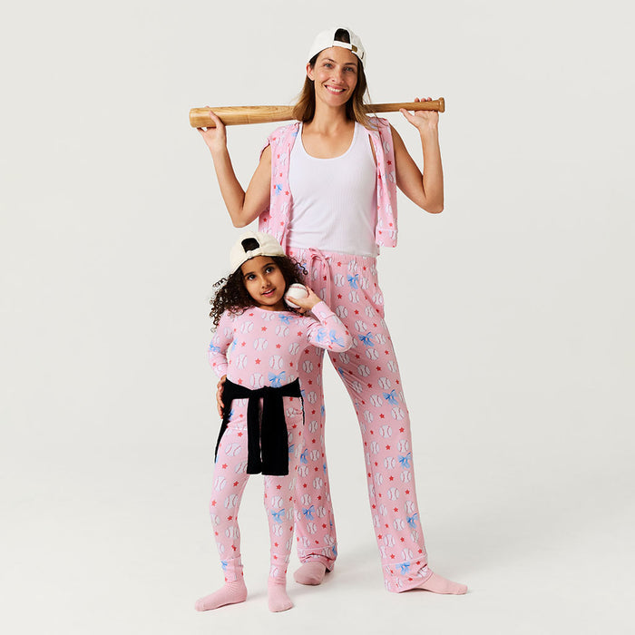 Woman and child wearing matching pink pajama sets with a white background