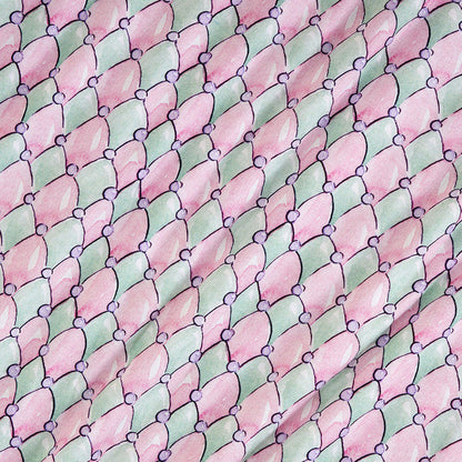 Pattern of pink and green diamonds with small purple circles on a textured background
