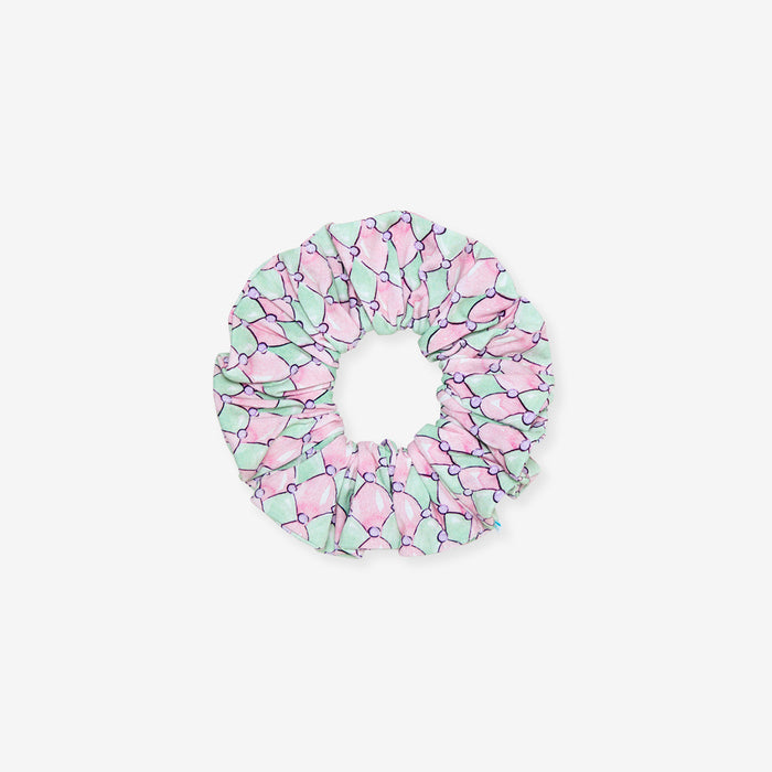 Pink and green patterned scrunchie on a white background