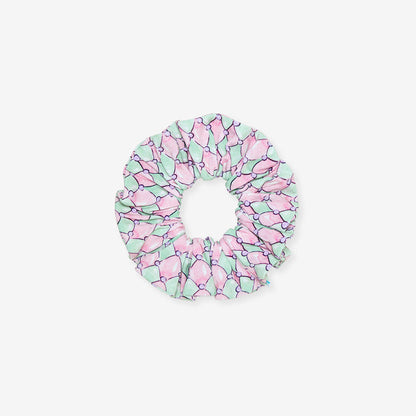 Pink and green patterned scrunchie on a white background