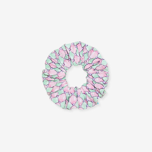 Pink and green patterned scrunchie on a white background