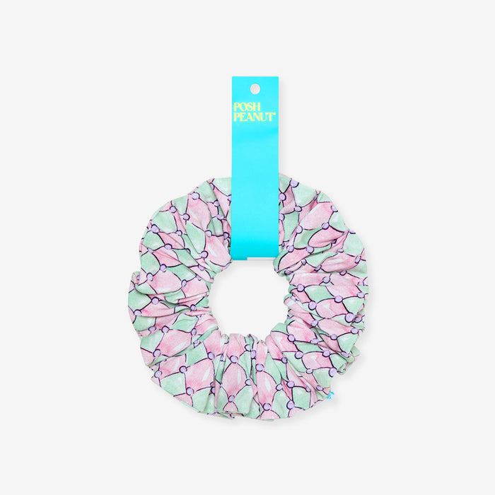 Pink and green scrunchie with a blue tag on a white background