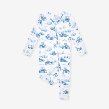 Baby one piece with blue tractor pattern on a white background